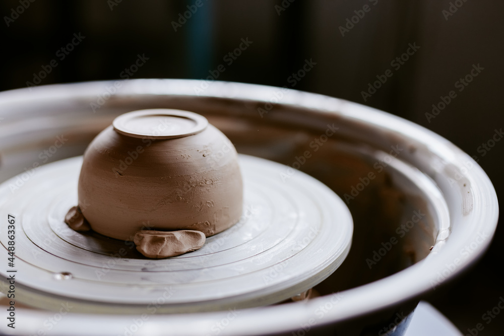 Clay cup on pottery wheel machine Clay cup on pottery wheel machine