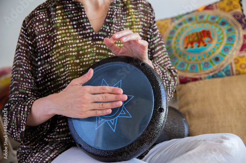 Female drummer hands playing darbuka percussion instrument. photo