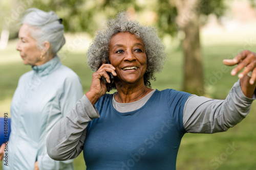 Older Woman Smiles While Talking on her Phone photo