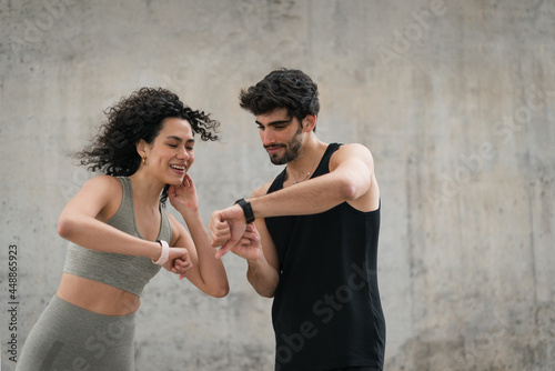 Fit couple using their smart band watch photo
