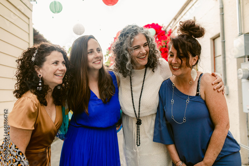 Group of women in dresses laughing together photo