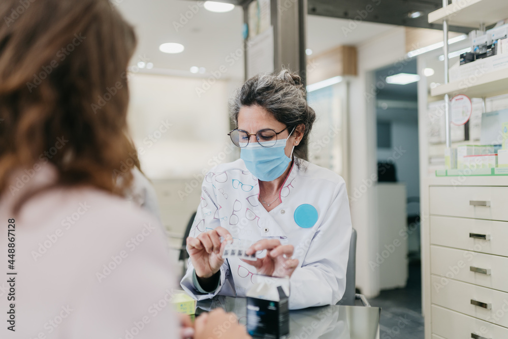 Woman wearing face mask shopping for glasses Woman wearing face mask shopping for glasses