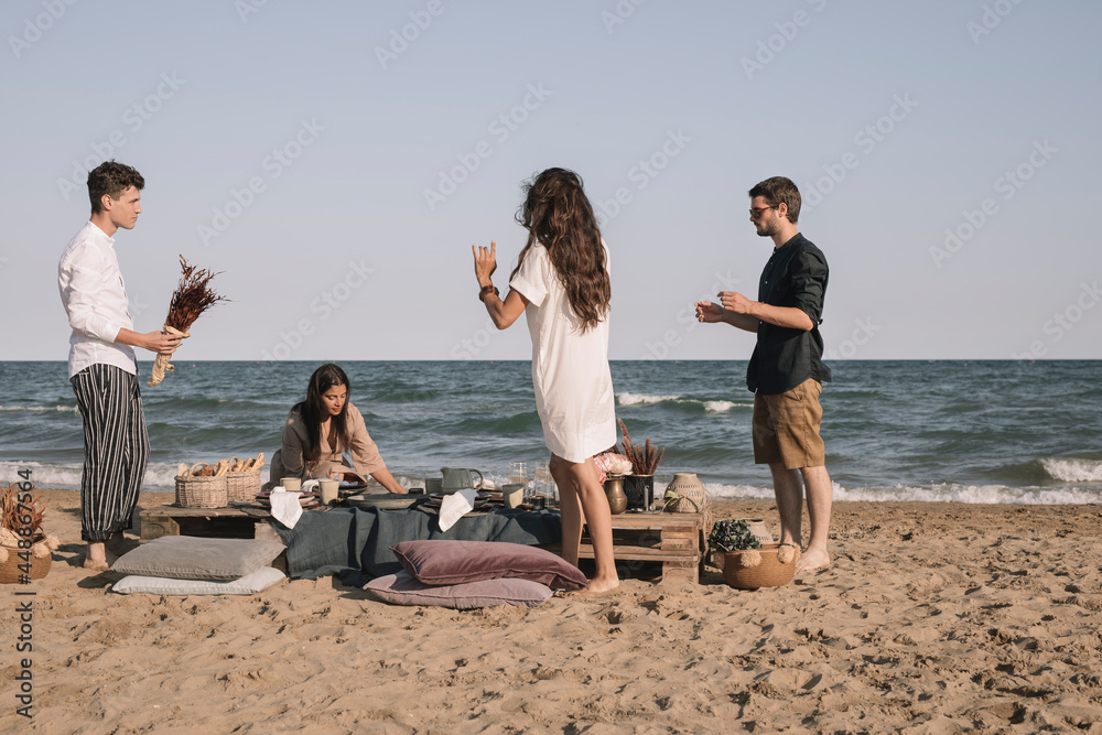 Friends Preparing Dinner Gathering On The Beach Friends Preparing Dinner Gathering On The Beach