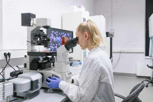 Woman Looking At Microscope

