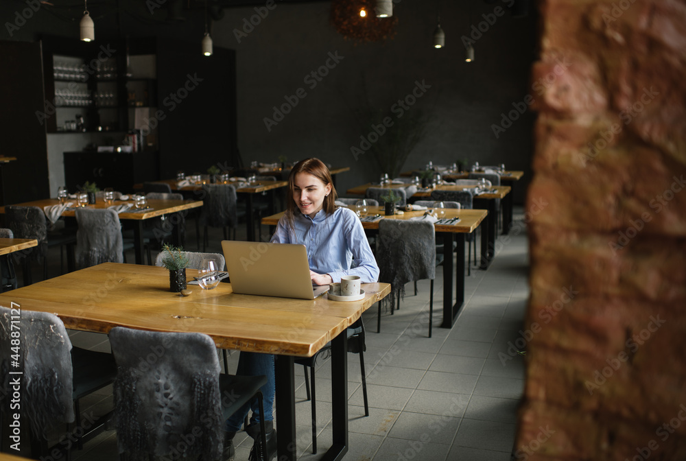 Woman In Restaurant Working With Computer Woman In Restaurant Working With Computer