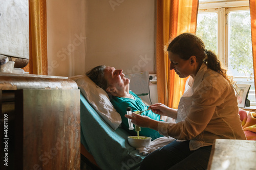 Feeding Paralysed Senior Woman At Home
 photo