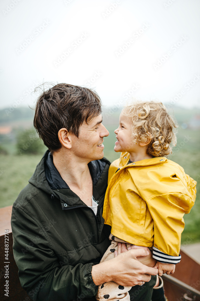 Outdoor image of father and child smiling