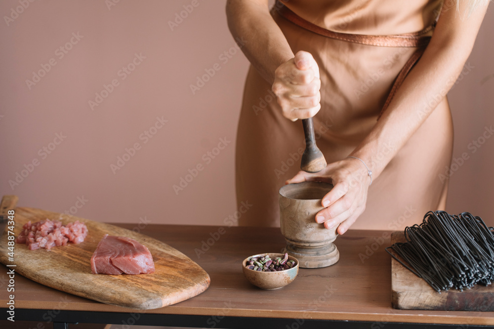 Anonymous Woman Crushing Pistachios For Spaghetti Anonymous Woman Crushing Pistachios For Spaghetti