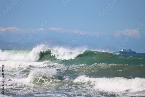 Ship & Huge waves crashing on coast Wellington New Zealand 