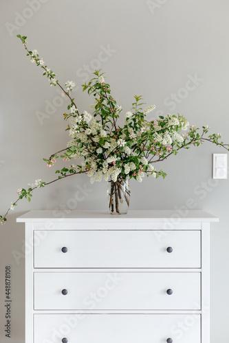 Bouquet of spring flowers on white cabinet photo