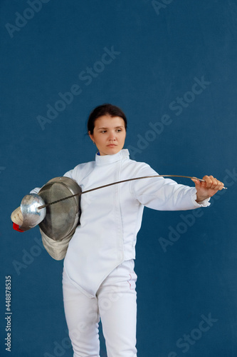 Female fencer checking weapon during training