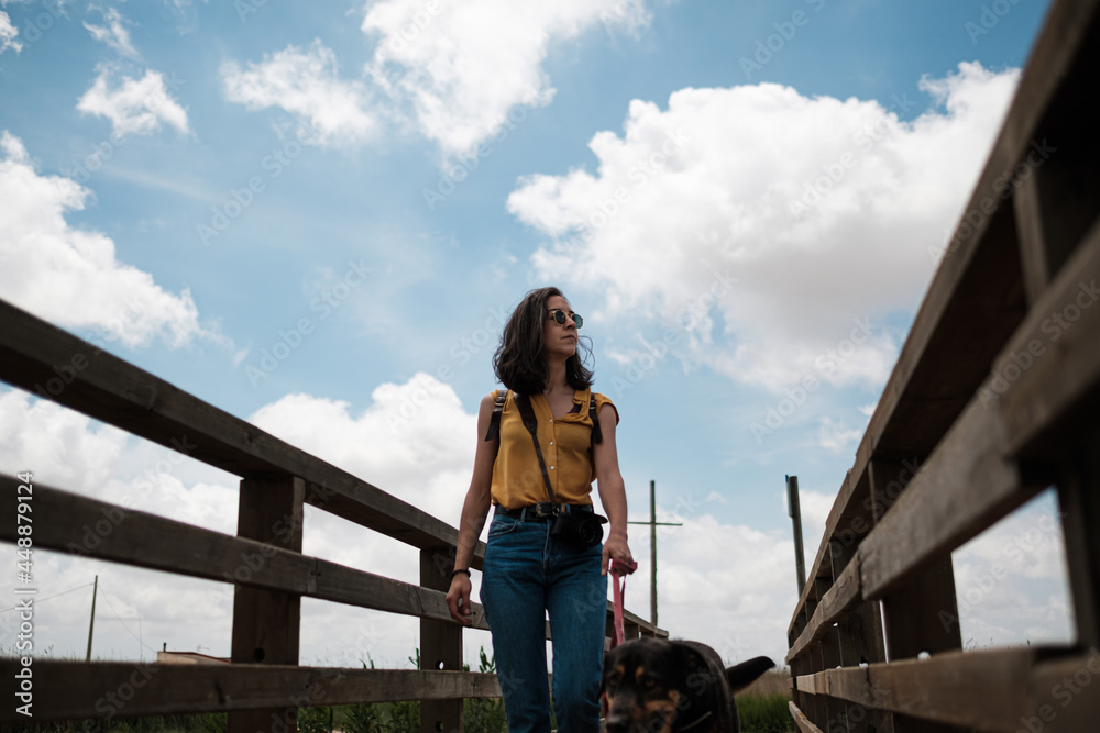 Young woman taking a walk with her dog Young woman taking a walk with her dog