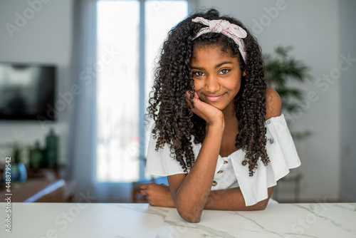 Portrait of a beautiful young black teenage girl looking into camera photo