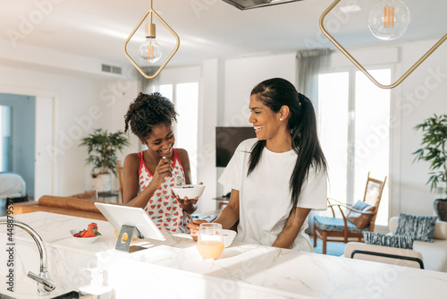 Happy mother and daughter having breakfast together photo