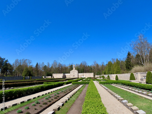 Military Cemetery in Riga. Main burial field and further away - central sculpture 'Mother Latvia'. Sunny spring day