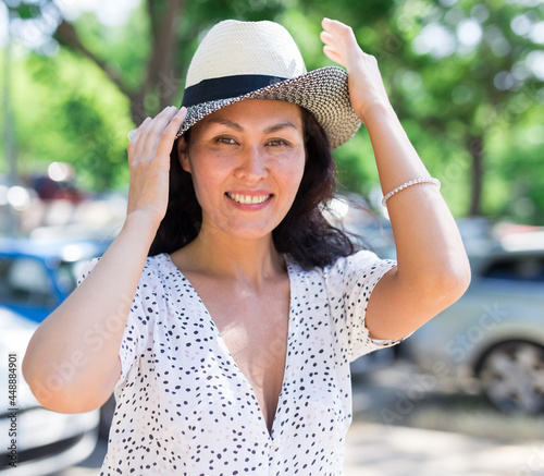 Portrait of Asian woman wearing white dress who walking outdoors in summertime photo