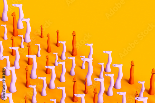 Colorful human legs on yellow background - copyspaced