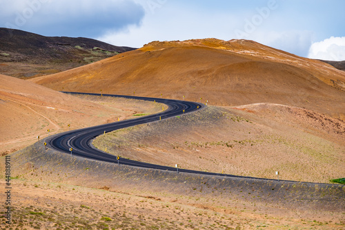 Winding paved road in desert, barren landscape