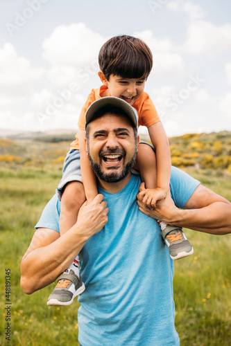 Happy dad with son having fun in countryside photo