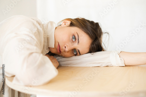 Portrait Of A Young Woman Leaning On A Table photo