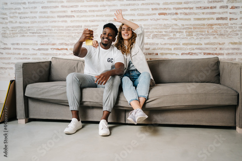 Happy diverse couple using smartphone photo