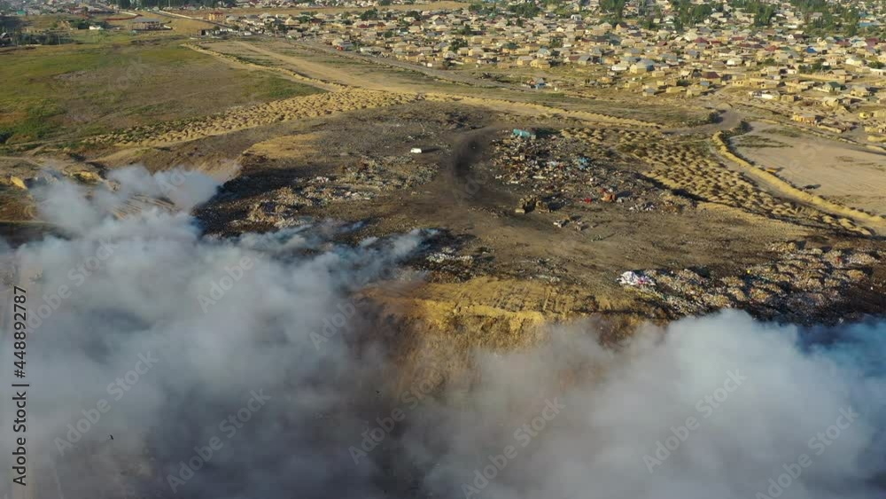 Aerial view of burning garbage pile in trash dump or landfill Aerial view of burning garbage pile in trash dump or landfill