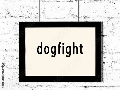 Tablou canvas Black frame hanging on white brick wall with inscription dogfight