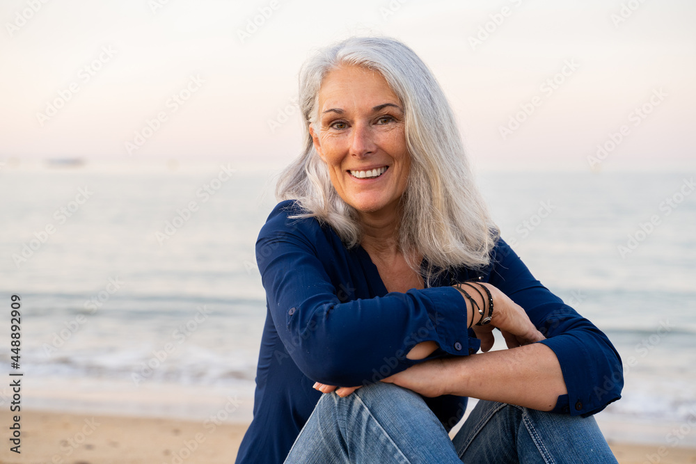 Beautiful mature woman relaxing at beach