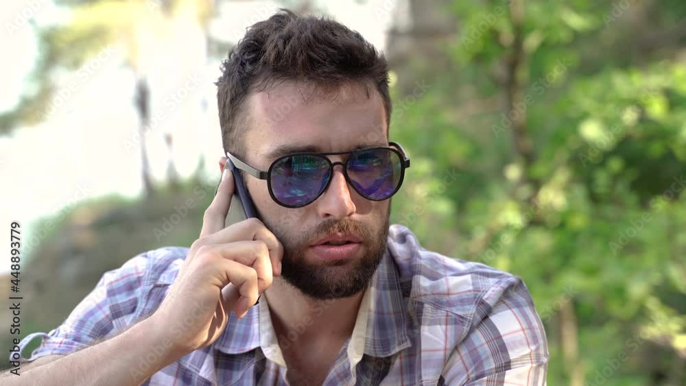 Mobile phone. The man is talking on a cell phone. Mobile phone. The man is talking on a cell phone.