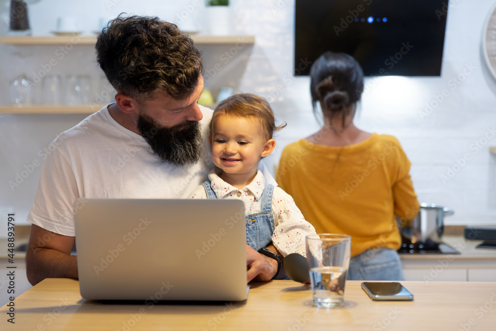 Father and toddler watching cartoon on laptop Father and toddler watching cartoon on laptop