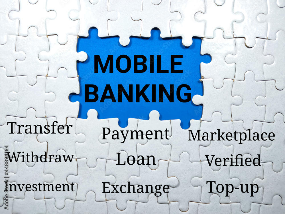Text MOBILE BANKING writing on blue background with jigsaw puzzle.Business mobile banking concept. Text MOBILE BANKING writing on blue background with jigsaw puzzle.Business mobile banking concept.