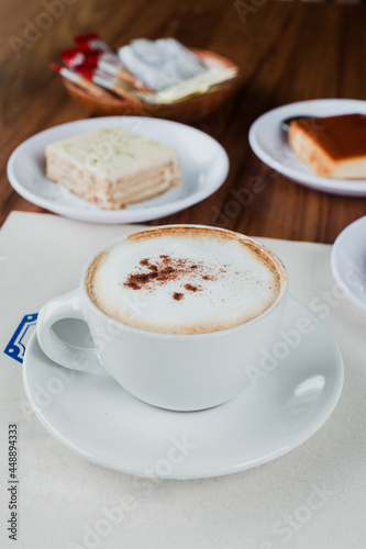 Cup of cappuccino coffee and desserts in cafeteria in Mexico City