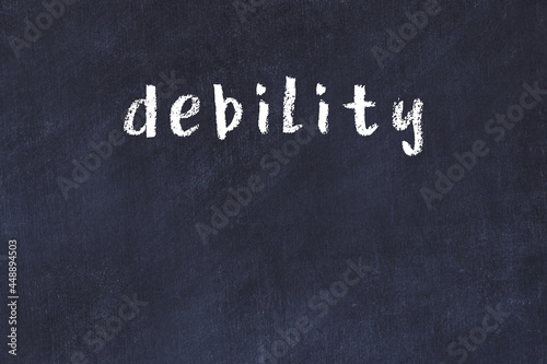 Фотография College chalk desk with the word debility written on in