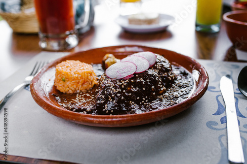 Mole poblano with red rice traditional mexican cuisine in Mexico City restaurant
