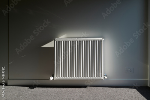 Empty room of new home with radiator heater photo