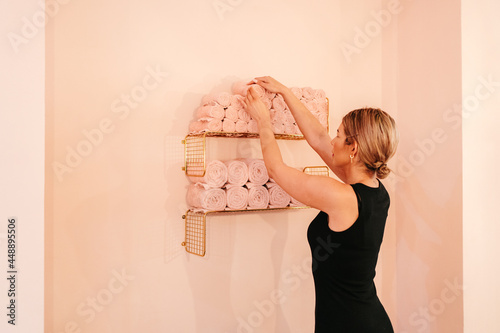 Rolled up towels on shelves in salon photo