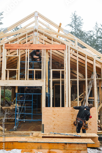 Man working on the roof doing construction in winter