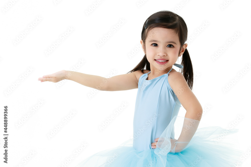 Portrait close up isolated studio shot of small pretty Asian preschool pigtails ballerina dancer girl in blue tutu ballet dress stand smile look at camera hold hand up for product on white background Portrait close up isolated studio shot of small pretty Asian preschool pigtails ballerina dancer girl in blue tutu ballet dress stand smile look at camera hold hand up for product on white background