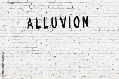 Inscription alluvion painted on white brick wall