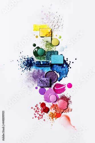 Colourful cosmetics flat lay rainbow with powder, liquid and glitter photo