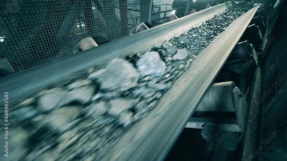 Metal transporter is moving fast with crushed minerals on it