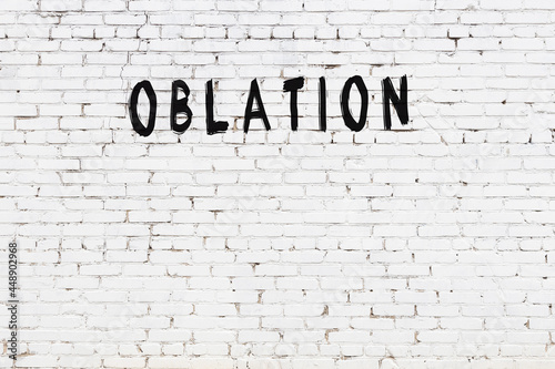 White wall with black paint inscription oblation on it