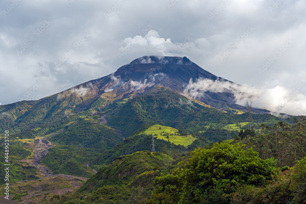 Tungurahua volcano with steam volcanic activity and dramatic clouds, Banos, Ecuador.