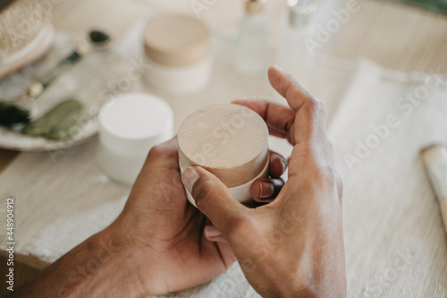 Detail of male hands holding face cream