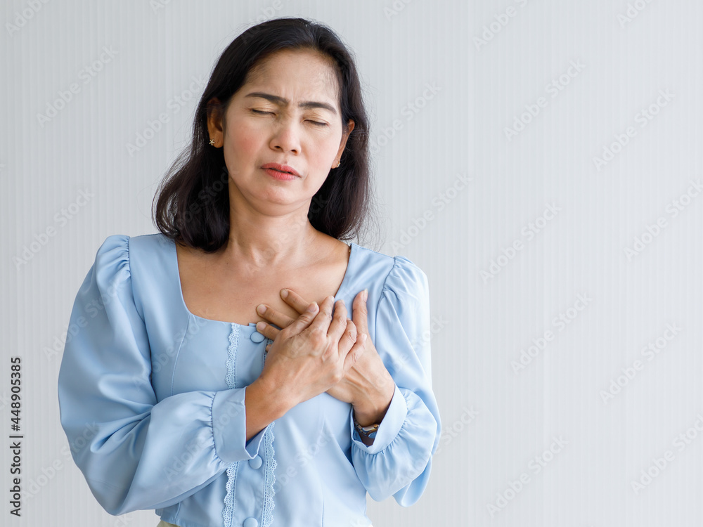 Adult woman with sudden heart attack and hold chest with pain face. Concept of emergency health care and affected from Congestive Failure or Cardiopulmonary Resuscitation, heart problem Adult woman with sudden heart attack and hold chest with pain face. Concept of emergency health care and affected from Congestive Failure or Cardiopulmonary Resuscitation, heart problem