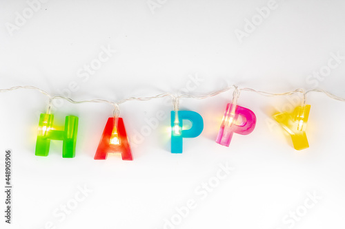 colorful resin letter word is HAPPY alphabet decorate with lights isolated on white background
