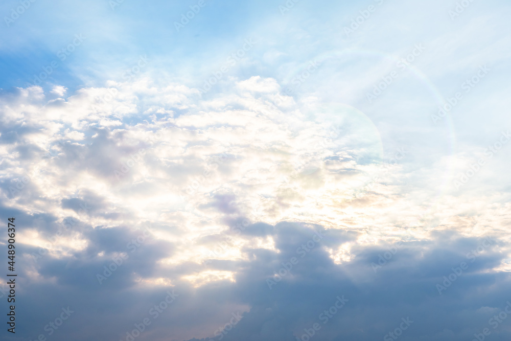 Beautiful sky glow through the clouds of the evening warm sun with cloud before sunset..Sunny sky abstract background, beautiful cloudscape, on the heaven, view over white fluffy clouds.