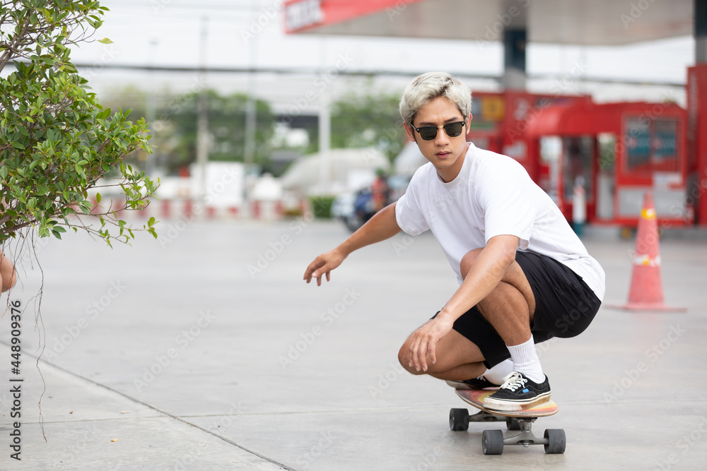 Fototapeta premium young man skater riding on skateboard