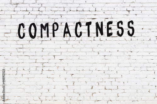 Fotografie Inscription compactness painted on white brick wall