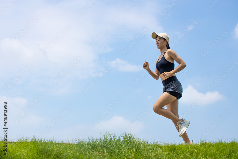 Young Asian girls running in the morning for fitness Young Asian girls running in the morning for fitness
